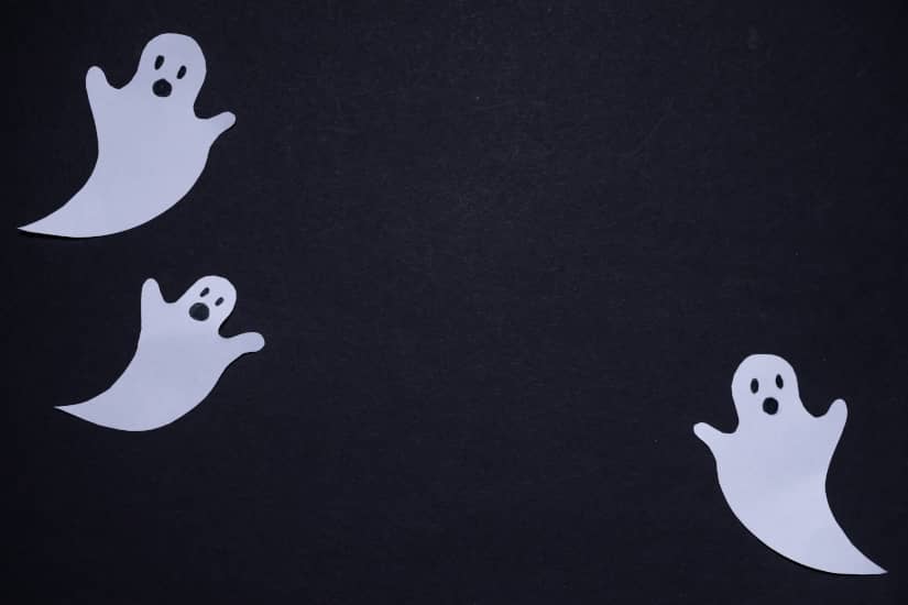 Three white ghosts on a black background.