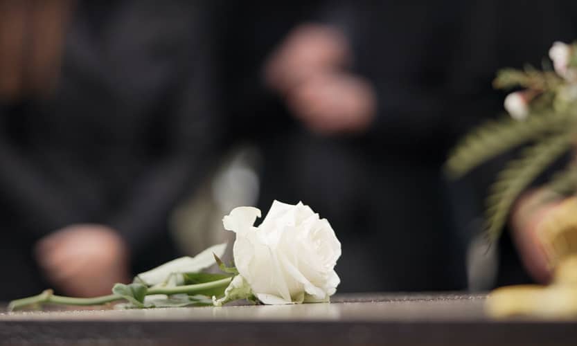 a rose at a funeral memorial service